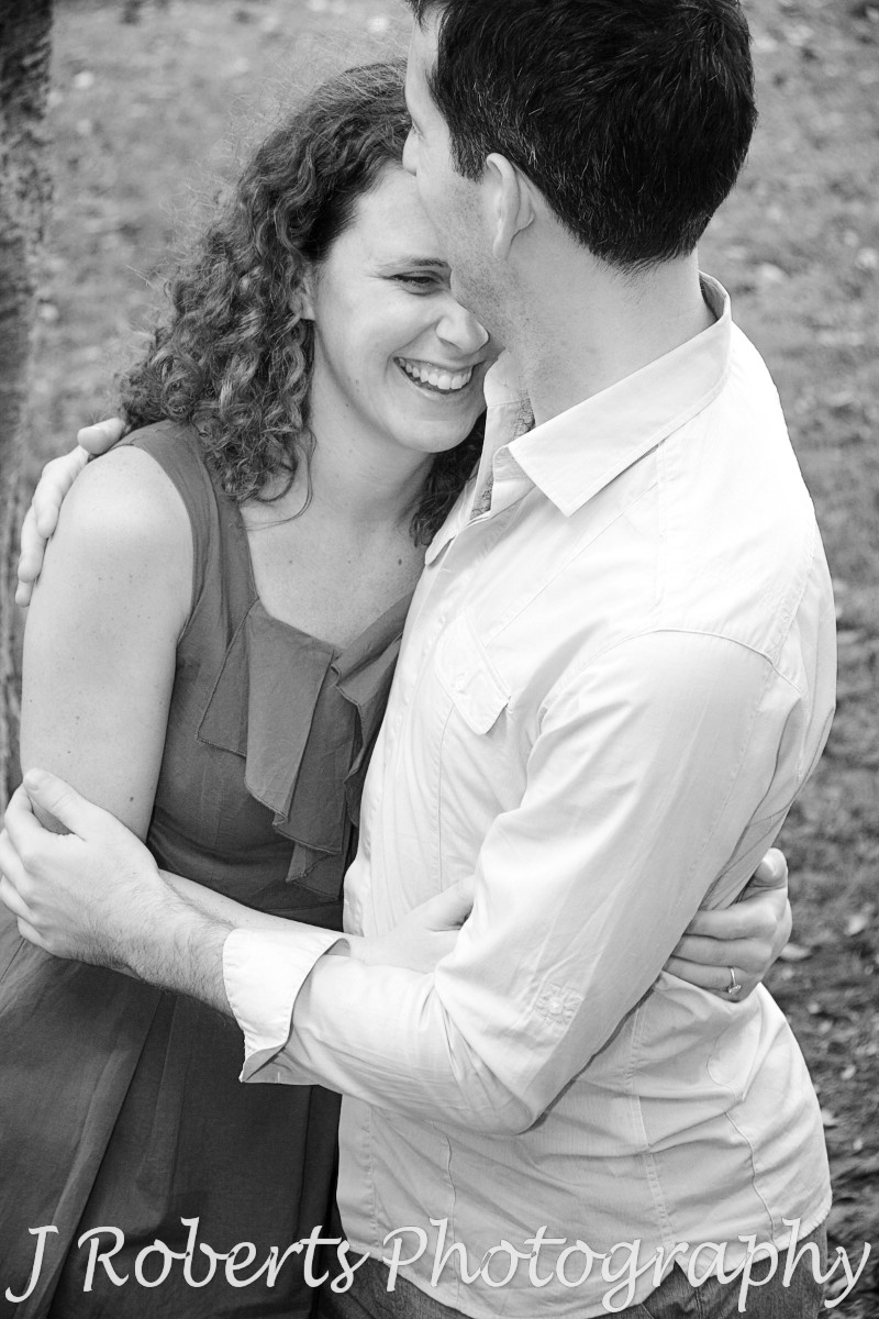 Embracing laughing couple in B&W - engagement photography sydney